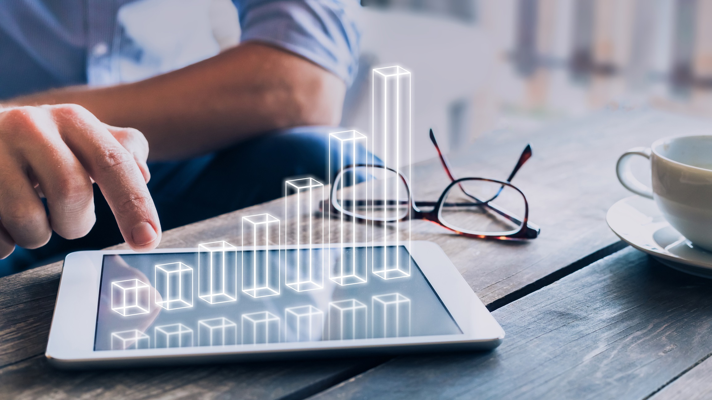 Businessman analyzing growing 3D AR chart above tablet computer screen